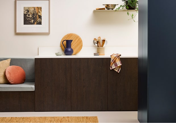 Dark wood cabinetry and built in seating bench