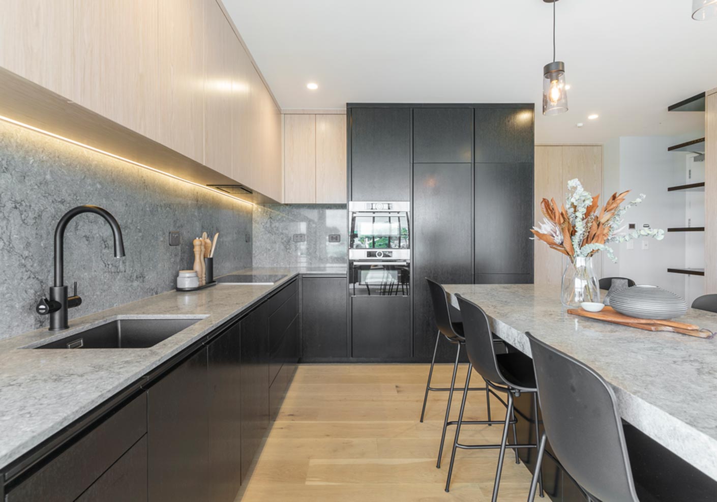 Minimalist warm timber tones cabinetry grey marble countertop